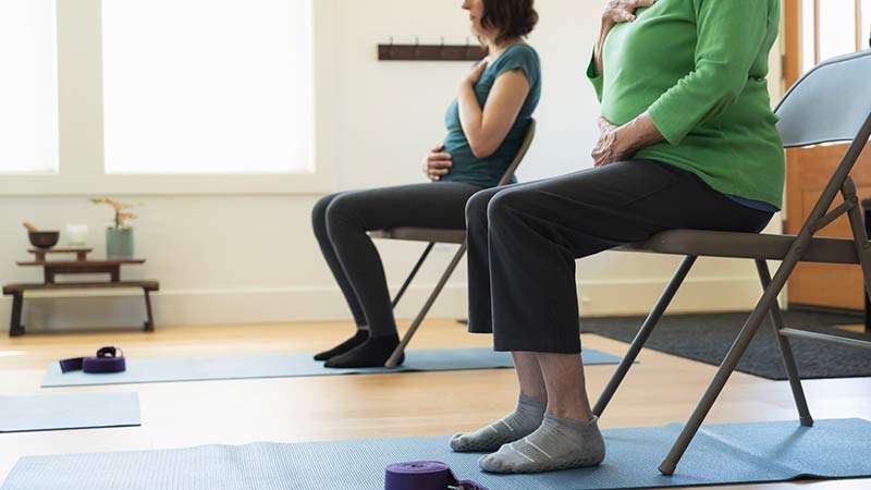 Hands-on-Bellies Yoga Instructor Makes Adjustment